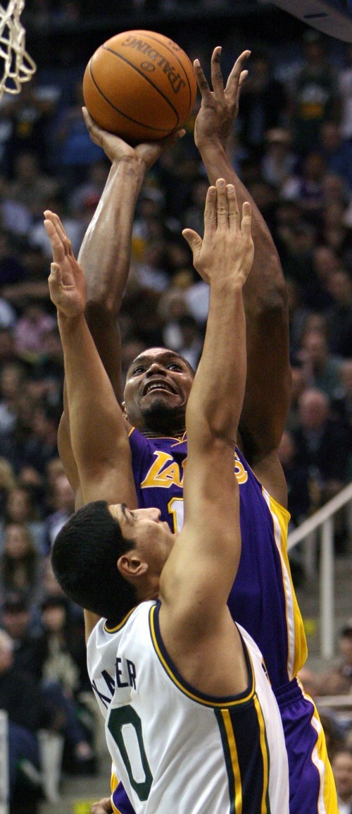 Steve Griffin  |  The Salt Lake Tribune

Utah's Enes Kanter defends the shot of Andrew Bynum, of the Lakers, during first half action of the Jazz versus Lakers game at EnergySlutions Arena in Salt Lake City, Utah  Wednesday, January 11, 2012.