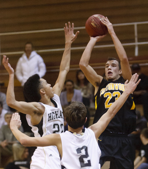 Trent Nelson  |  The Salt Lake Tribune
Cottonwood's Ryan Mackay shoots the ball, defended by Highland's Liam Thomas, left, and David Divver, as Highland faces Cottonwood High School, boys basketball in Salt Lake City in December.