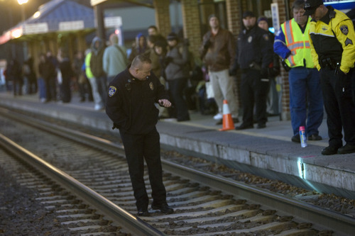 Kim Raff |The Salt Lake Tribune
A passengers watch as South Salt Lake and UTA Police investigate an accident on the southbound red line at the UTA Trax Central Pointe Station in South Salt Lake City, Utah on January 12, 2012.