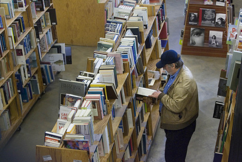 Paul Fraughton | The Salt Lake Tribune.
 A customer  checks out the new location of Sam Weller Books, once a stalwart of downtown Salt Lake, now in Trolley Square with a  new name, Weller Book Works.
 Friday, January 13, 2012