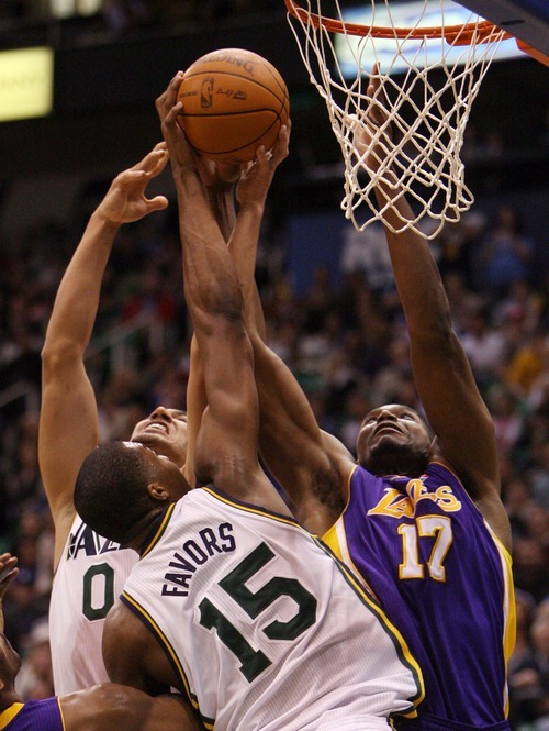 Steve Griffin  |  The Salt Lake Tribune

Utah's Enes Kanter and Derrick Favors battle Andrew Bynum, of the Lakers, during first half action of the Jazz versus Lakers game at EnergySlutions Arena in Salt Lake City, Utah  Wednesday, January 11, 2012.