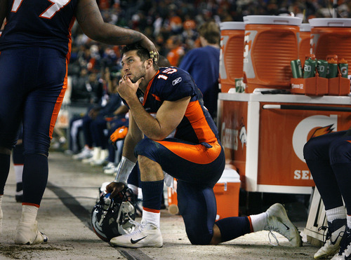 Scott Sommerdorf  |  The Salt Lake Tribune             
Broncos QB Tim Tebow gets some consolation from Denver DT Marcus Thomas in the closing minutes of the loss to the Patriots. The New England Patriots beat the Denver Broncos 41-23, Sunday, December 18, 2011.