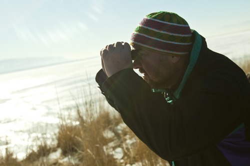 Chris Detrick  |  The Salt Lake Tribune
Tom Pilger uses binoculars to look at bald eagles during an outing led by Hawk Watch International at Farmington Bay Bird Refuge Saturday January 14, 2012.