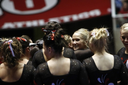 Chris Detrick  |  The Salt Lake Tribune
Kyndal Robarts is congratulated by her teammates after competing on the beam during the gymnastics meet against Utah State at the Huntsman Center Friday January 13, 2012.