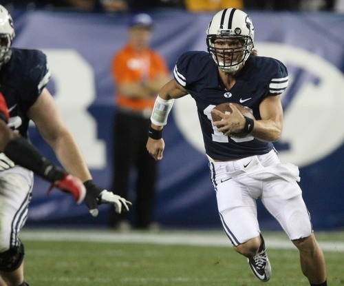 Rick Egan  | The Salt Lake Tribune 

BYU QB, Riley Nelson runs the ball for the Cougars, late in the fourth quarter, as BYU lost to Utah 54-10, Saturday, September 17, 2011.
