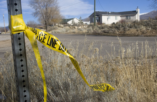 Al Hartmann  |  The Salt Lake Tribune
Crime scene tape remains near 399 South and 600 East in Mount Pleasant on Tuesday. The house at right is the residence of Leroy and Dorotha Fullwood, who were killed on Dec. 30.