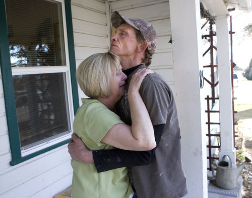 Al Hartmann  |  The Salt Lake Tribune
Denise Atwood cries Tuesday as her husband, Mike, holds her on the front porch of their Fairview home after hearing that their daughter, Angela Atwood, was captured in Nevada. Angela Atwood is one of the two suspects of a crime spree that claimed the lives of a Mount Pleasant couple and left a woman seriously injured. 
