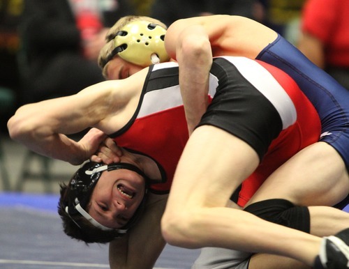 Rick Egan  | The Salt Lake Tribune 

Josh Pettus of Hurricane, (red) wrestles Kyle Robison, (blue) Millard, in the 106 lb division, in The Rocky Mountain Rumble wrestling tournament in Orem, Saturday, January 14, 2012.