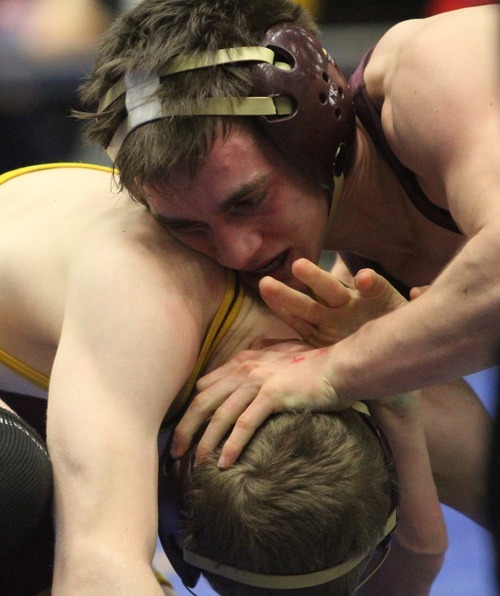 Rick Egan  | The Salt Lake Tribune 

Britain Carter, Maple Mountain, (top) wrestles Dusty Hone, Cedar, in the 113 lb division, in The Rocky Mountain Rumble wrestling tournament in Orem, Saturday, January 14, 2012.