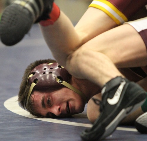 Rick Egan  | The Salt Lake Tribune 

Britain Carter, Maple Mountain, (bottom) wrestles Dusty Hone, Cedar, in the 113 lb division, in The Rocky Mountain Rumble wrestling tournament in Orem, Saturday, January 14, 2012.