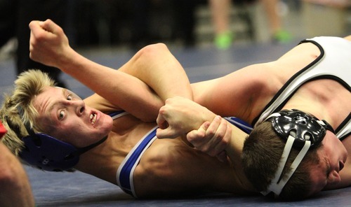 Rick Egan  | The Salt Lake Tribune 

ANdrew Cunningham, Bonney Lake wrestles Korbin Levin, Pleasant Grove, (blue) in the 120 lb division, in The Rocky Mountain Rumble wrestling tournament in Orem, Saturday, January 14, 2012.