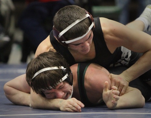 Rick Egan  | The Salt Lake Tribune 

Hayden Tuma, (top) wrestles Jed Mellen, Payson (black) in the 132 lb division, in The Rocky Mountain Rumble wrestling tournament in Orem, Saturday, January 14, 2012.