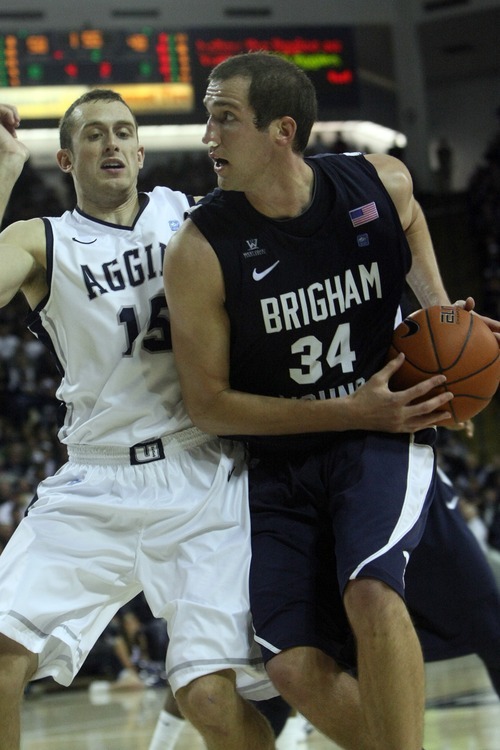 Chris Detrick  |  The Salt Lake Tribune
Brigham Young Cougars forward Noah Hartsock (34) is guarded by Utah State Aggies forward Mitch Bruneel (15) during the second half of the game at the Dee Glen Smith Spectrum Friday November 11, 2011. Utah State won the game 69-62.