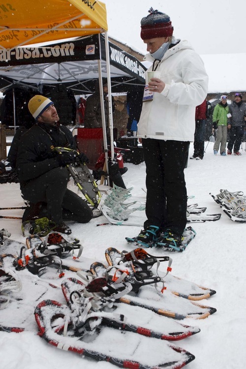 Trent Nelson  |  The Salt Lake Tribune
Connor Folley, Marketing Manager for K2 Outdoor, fits Els Fonteyne with a pair of snow shoes at Mountain Demo Day, which kicked off the Outdoor Retailer Winter Market trade show Wednesday at Solitude Mountain Resort. Attendees were able to examine and try out the latest in winter sports equipment.