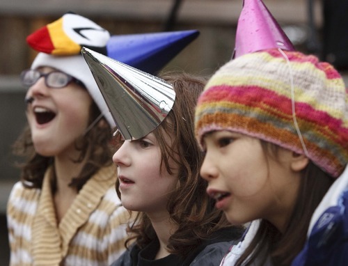 Leah Hogsten  |  The Salt Lake Tribune
l-r Althea Deschenes, 10, Elle Deschenes, 8, and Mica Wheeler, 8, react to Andy, the Andean Condor from Tracy Aviary rippping open his birthday presents filled with treats of meat and fish while celebrating his 53rd birthday with the public with games, crafts, and cake Saturday, January 21, 2012 at the aviary.