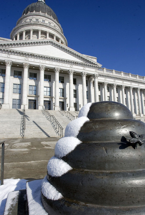 Al Hartmann  |  The Salt Lake Tribune
Monday's night's light snow clings to the side of the beehive statues in front of the Utah Capitol Tuesday morning as sun and blue sky appeared for the second day of the 2012 legislative session.