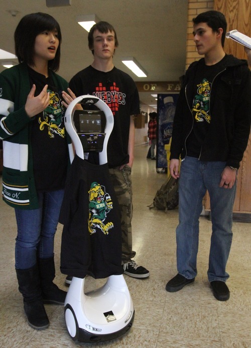 Rick Egan  | The Salt Lake Tribune
Kearns High School students, from left: Thao Nguyen, Zach Lester and Eric Mijanos, talk on Thursday about the robot they raised funds for. The Kearns High OK Club raised $3,500 toward the donation of a VGo robot to Primary Children's Medical Center. The robot is able to attend class for a patient, relaying video of class in real-time and asking questions for the patient.