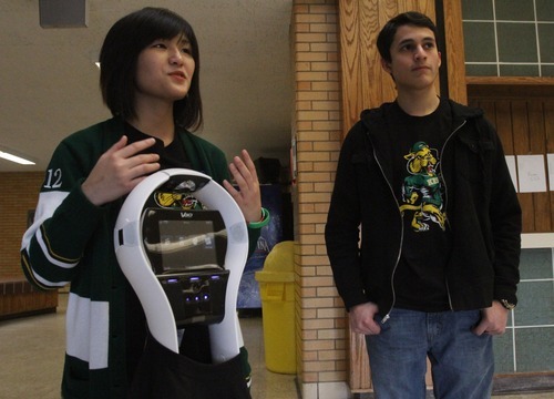 Rick Egan  | The Salt Lake Tribune
Kearns High School students Thao Nguyen, left, and Eric Mijanos talk on Thursday about the robot they raised funds for. The Kearns High OK Club raised $3,500 toward the donation of a VGo robot to Primary Children's Medical Center. The robot is able to attend class for a patient, relaying video of class in real-time and asking questions for the patient.