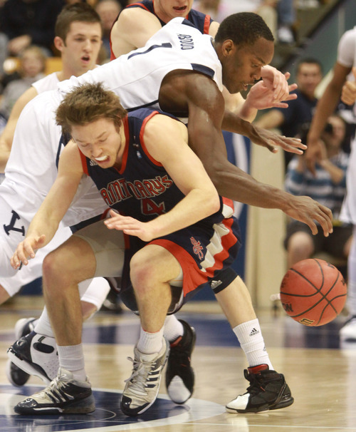 Rick Egan  | The Salt Lake Tribune 

Brigham Young Cougars guard/forward Charles Abouo (1) collides with St. Mary's Gaels guard Matthew Dellavedova (4) in basketball action, BYU vs. St Mary's in the Marriott Center in Provo, Saturday, January 28, 2012.