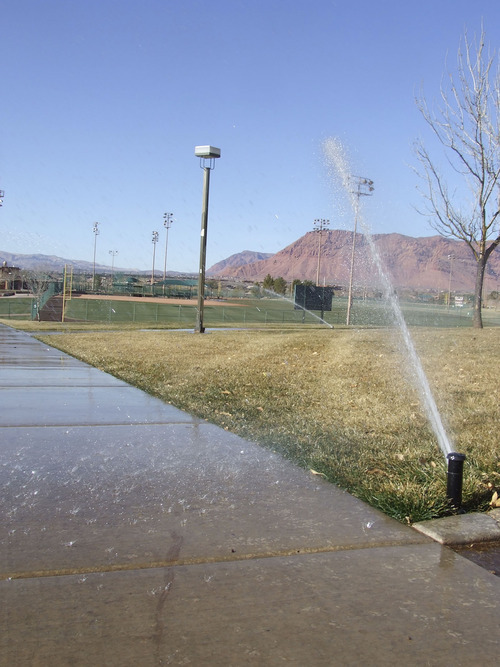 Brandon Loomis | The Salt Lake Tribune
Sprinklers keep a St. George park green amid the orange desert of southwest Utah. Washington County was one of the fastest-growing communities in the nation before the economic downturn, and local officials say it will be again -- and will need to tap a new water source across the state in Lake Powell.