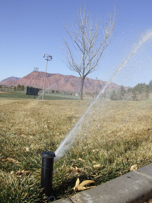 Brandon Loomis | The Salt Lake Tribune
Sprinklers keep a St. George park green amid the orange desert of southwest Utah. Washington County was one of the fastest-growing communities in the nation before the economic downturn, and local officials say it will be again -- and will need to tap a new water source across the state in Lake Powell.