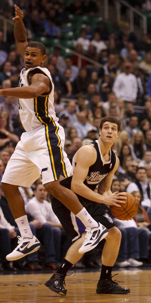 Trent Nelson  |  The Salt Lake Tribune
Sacramento's Jimmer Fredette looks for a shot in the first half, with Utah Jazz guard Earl Watson (11) defending, Saturday at the EnergySolutions Arena in Salt Lake City. The Jazz downed the Kings, 96-93.