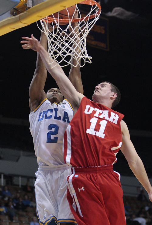 UCLA guard Kenny Jones (2) goes up for a basket as Utah's Alex Mortensen (11) defends in the second half of an NCAA college basketball game Thursday, Jan. 26, 2012, in Los Angeles. UCLA won 76-49. (AP Photo/Jason Redmond)
