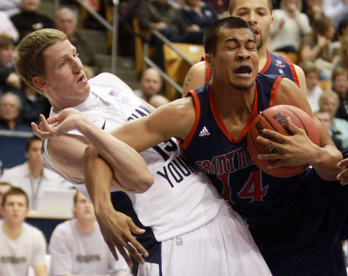 BYU guard, Brock Zylstra (13) gets tangles up with Saint  Mary's guard Stephen Holt (14),  during an NCAA college basketball game at the Marriott Center in Provo, Utah Saturday, Jan. 28, 2012. (AP Photo/The Salt Lake Tribune, Rick Egan)