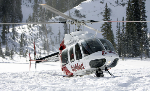 Francisco Kjolseth  |  The Salt Lake Tribune
An AirMed chopper sinks below the snow line with a partially turned bear claw on its skid meant to keep it above snow prompting the pilot to take off again while transporting local teams of highly-trained avalanche rescue dogs and their handlers into the back country for training at Brighton resort on Wednesday, January 25, 2012.