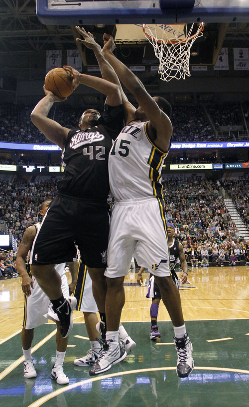 Sacramento Kings center Chuck Hayes (42) attempts a shot while defended by Utah Jazz center Derrick Favors (15) during the second half of an NBA basketball game, Saturday, Jan. 28, 2012, in Salt Lake City. The Utah Jazz won 96-93. (AP Photo/Jim Urquhart)