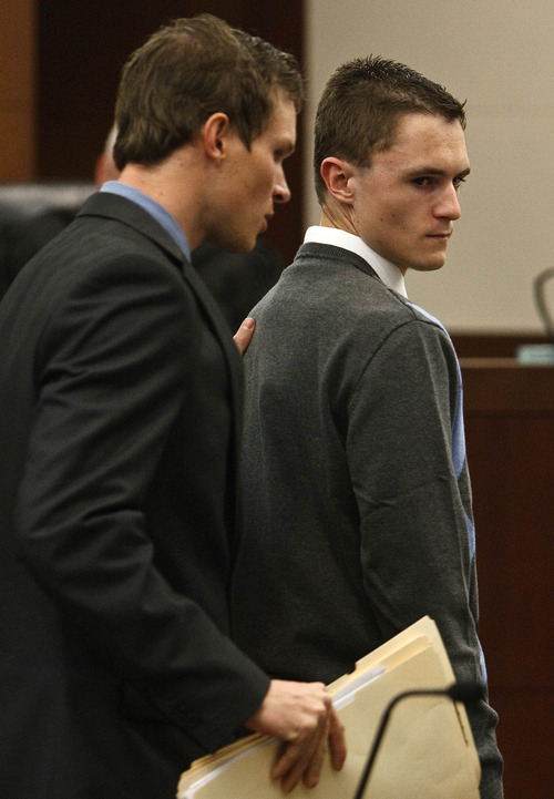 Leah Hogsten  |  The Salt Lake Tribune
Dallin Todd Morgan, the 18-year-old Roy High School student charged with plotting to bomb the school with the help of a 16-year-old co-conspirator and fellow student, appeared before Ogden, Utah's 2nd District Court Judge W. Brent West Wednesday, February 1, 2012. Morgan, right, is led out of the courtroom by his attorney Kristopher Greenwood, left. Police say the teens, both Roy High seniors, had planned to set off a bomb during a school assembly, then steal an airplane and fly to another country.