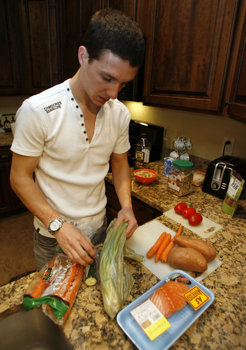 Francisco Kjolseth  |  The Salt Lake Tribune
Real Salt Lake player Will Johnson preps an upcoming meal of rice, salmon and veggies at his home on Thursday, Jan. 26, 2012. Will gets nutritional counseling to make sure he's eating properly for endurance and for his sensitive stomach.