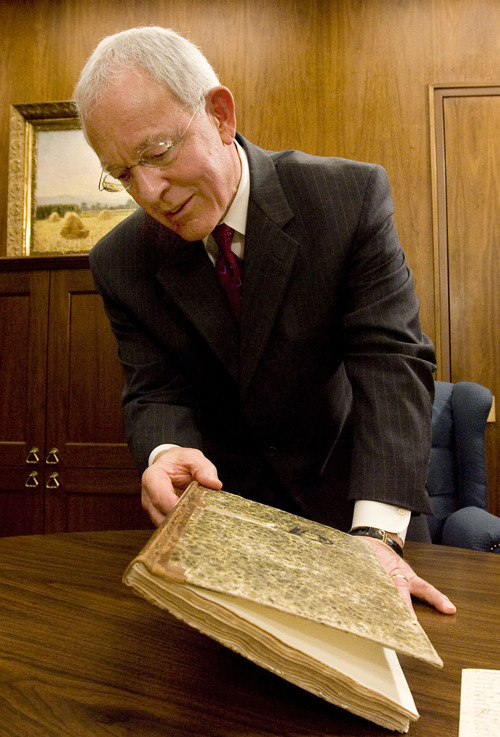 In his office in the LDS Church Office Building in Salt Lake City, Elder Marlin Jensen holds a journal that contains dictated and handwritten entries from Joseph Smith from 1835 and 1836. The journal is part of the LDS Church's Joseph Smith Papers Project. Jensen has been replaced as the church's historian. Monday, February 25, 2008.  Steve Griffin/The Salt Lake Tribune 2/20/08