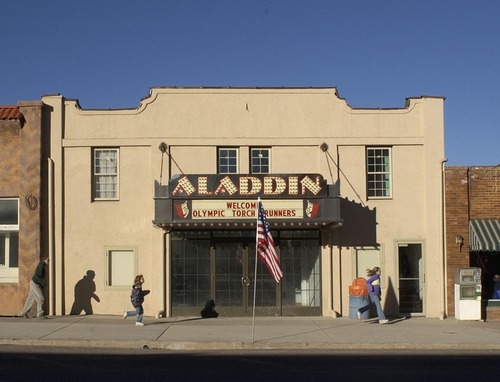 Steve Griffin | Tribune file photo
Kids run past the Aladdin Theatre in Parowan as they await the arrival of the torch.