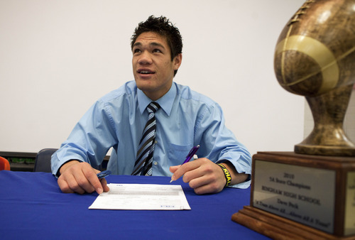 Jim Urquhart | Special to the Salt Lake Tribune
Jared Afalava signs a letter of intent to play college football at Nebraska during signing day at Bingham High School Wednesday, Feb. 1, 2012.