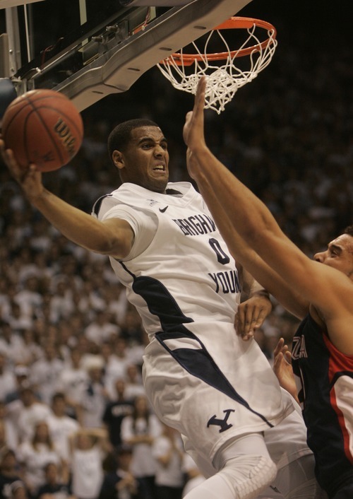 Kim Raff |The Salt Lake Tribune
BYU player Brandon Davies passes around the arms of Gonzaga player Elias Harris during the first half of a game at the Marriott Center in Provo, Utah on February 2, 2012.
