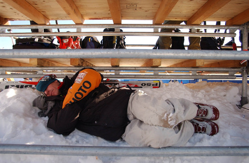Tribune file photo
A Sports Illustrated Daily photographer takes a nap during a weather delay at the Women's Downhill event at Snowbasin during the 2002 Games.