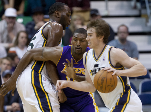 Trent Nelson  |  The Salt Lake Tribune
Utah's Gordon Hayward, right drives past the Lakers' Metta World Peace during the Jazz's home victory Saturday night.