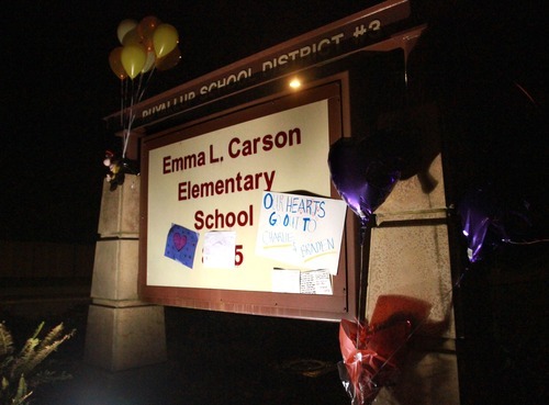 Rick Egan  | The Salt Lake Tribune 

Friends and neighbors of Charlie and Braden Powell left notes, balloons, and stuffed animals at the memorial at Carson Elementary School in Puyallup,  Washington, Sunday, February 5, 2012.