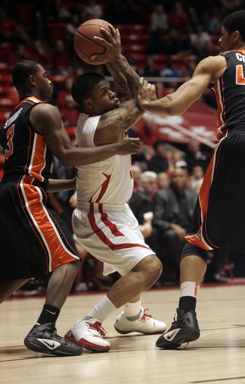 Kim Raff |The Salt Lake Tribune
University of Utah player (middle) Kareem Storey is surrounded by Oregon State players (left) Ahmad Stark and Devon Collier during the first half at the Huntsman Center in Salt Lake City, Utah on February 4, 2012.