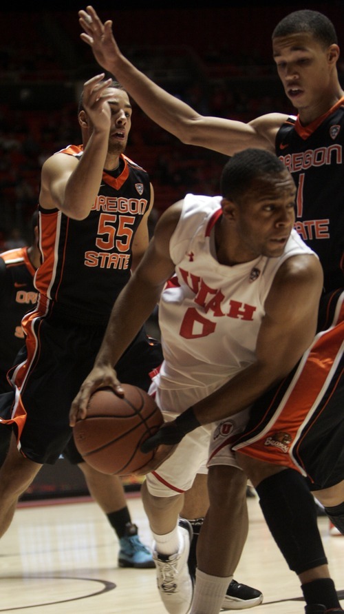 Kim Raff |The Salt Lake Tribune
University of Utah player Chris Hines looks for a pass as he is defended by Oregon State players (left) Roberton Nelson and Jared Cunningham during the first half at the Huntsman Center in Salt Lake City, Utah on February 4, 2012.