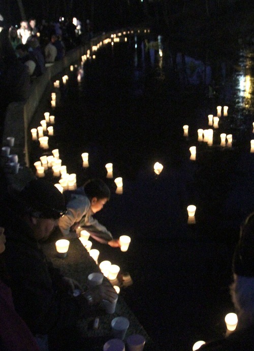 Rick Egan  | The Salt Lake Tribune 

Candles are placed into McKinley Pond during a vigil at McKinley Park in Tacoma, Monday, February 6, 2012.  Between 300 and 400 people attended the vigil.