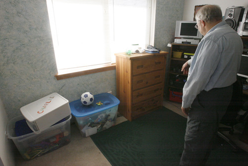 Rick Egan  | The Salt Lake Tribune 

Chuck Cox, father of Susan Powell, looks through Charlie and Braden's toy box, in the room where they used to play, in his home in Puyallup, Wash., on Monday, Feb. 6, 2012. His grandsons were killed by their father, Josh Powell, on Sunday.