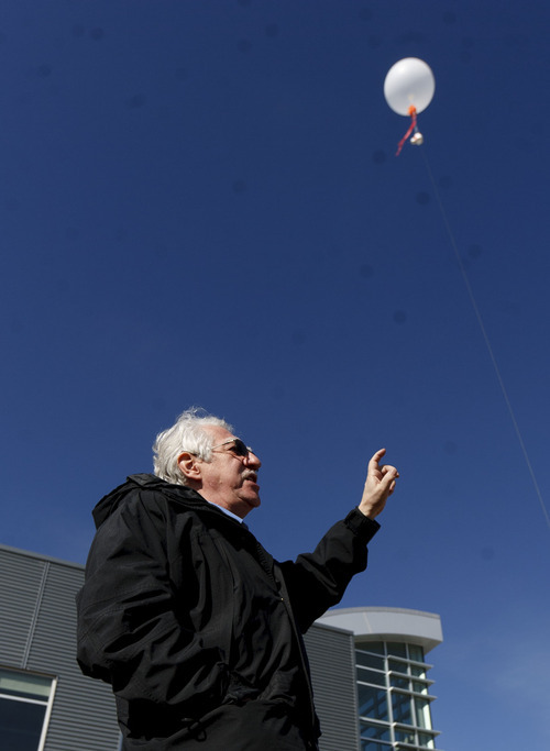 Trent Nelson  |  The Salt Lake Tribune
Russ Schnell, a deputy director with NOAA, demonstrates a balloon used to check air quality as government agencies and industry announced a Uinta Basin winter ozone study Tuesday in Vernal. The study intends to better understand why ozone levels occasionally soar above health-based standards in the winter.