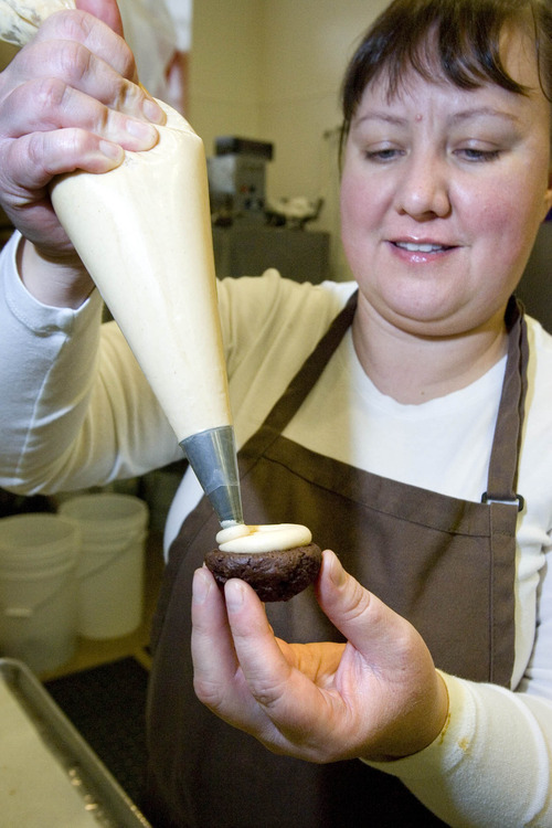 Paul Fraughton  |  The Salt Lake Tribune
Romina Rasmussen of Les Madeleines pipes the peanut butter cream cheese filling on one of her chocolate whoopie pies Wednesday.