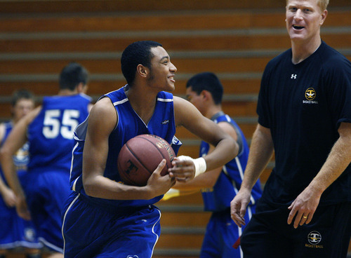 Scott Sommerdorf  |  The Salt Lake Tribune             
Sidney Freeman, #23, left runs with the ball as he jokes with Head Coach Coach Jim Boyce at Taylorsville High basketball practice, Saturday February 4, 2012.