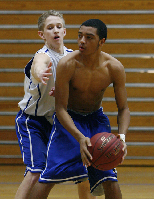 Scott Sommerdorf  |  The Salt Lake Tribune             
Jevin Warren, #30, left, guards Sidney Freeman, #23, at Taylorsville High basketball practice, Saturday February 4, 2012.