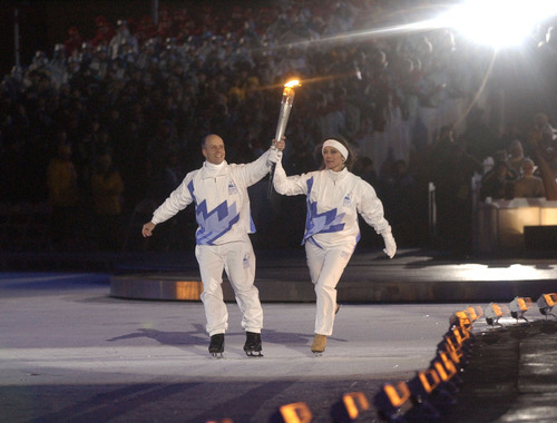 Rick Egan | The Salt Lake Tribune file photo
Figure skaters Scott Hamilton and Peggy Fleming carry the torch as it enters Rice-Eccles Stadium during the Opening Ceremony.
