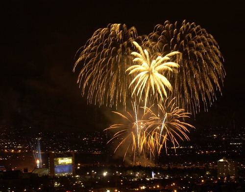 Al Hartmann | The Salt Lake Tribune file photo
A massive fireworks display at the end of the Opening Ceremony dwarfs the newly lit cauldron at Rice Eccles Stadium, seen in the lower left.