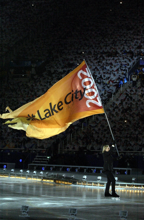 Tribune file photo
A skater carries a Salt Lake flag across the ice during the Opening Ceremony at Rice-Eccles Stadium.